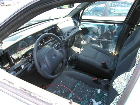 1991 Ford LTD Crown Victoria - Interior view of a 1991 Ford Crown Victoria LTD with a damaged dashboard and broken glass.