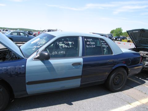 1991 Ford LTD Crown Victoria - This sedan has a light blue front and dark blue rear, with text written on the windows.