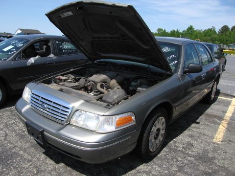 1991 Ford LTD Crown Victoria - Gray Ford Crown Victoria with hood open, parked in an outdoor lot with other vehicles.