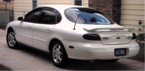 1997 Ford Taurus - This 1997 Ford Taurus is seen from the rear, a spoiler and a license plate reading SCE 660.