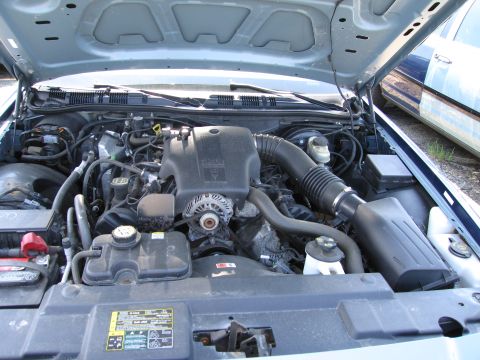1991 Ford LTD Crown Victoria - The engine compartment of a Ford Crown Victoria, likely from the early 2000s, is shown with the hood open.