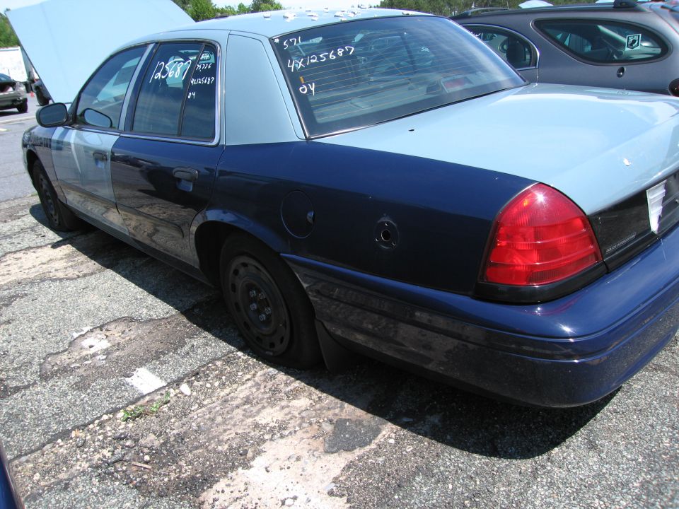 1991 Ford Crown Victoria with two-tone paint, hood up, flat tire