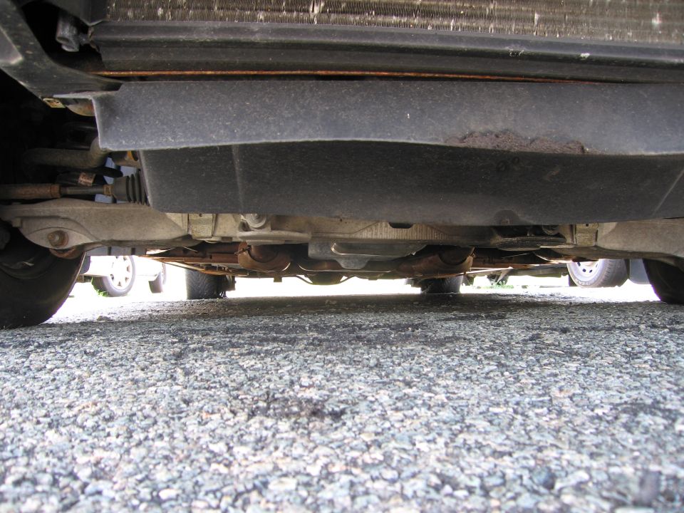Underside view of a vehicle showing suspension and exhaust components