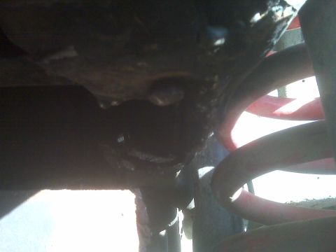 1969 Ford F-250 - Underside view of red coil springs and suspension components, with a Supermotors.net watermark.