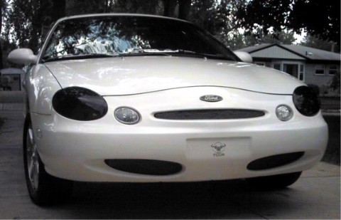 1997 Ford Taurus - This 1997 Ford Taurus is parked in front of a house with trees in the background.
