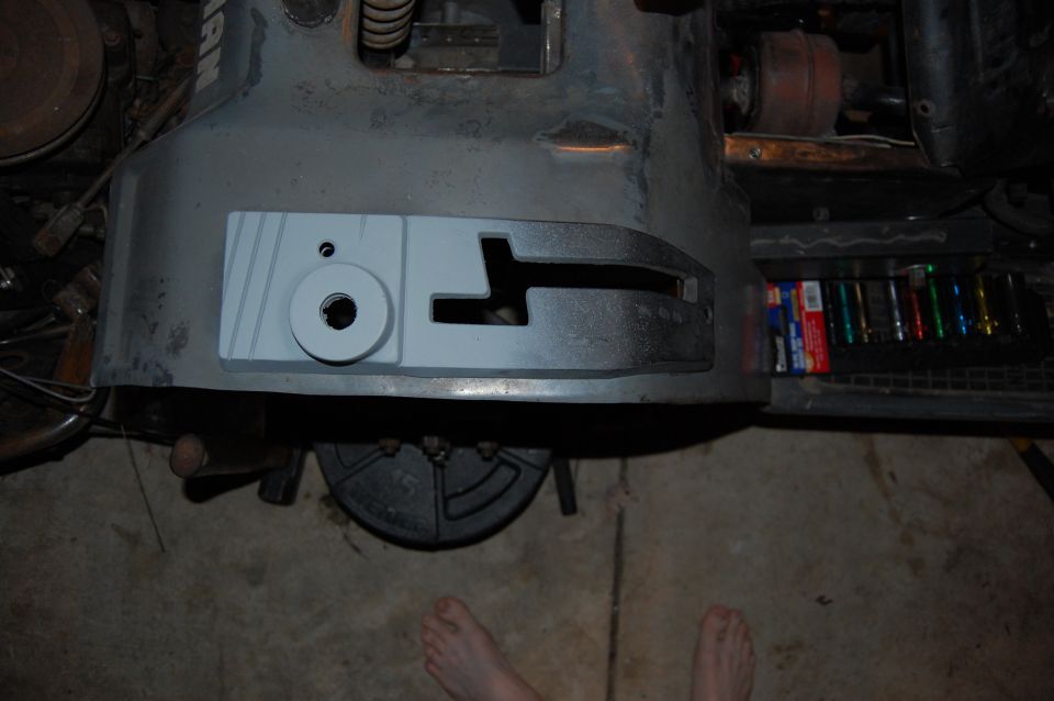 Gray machine part with circular hole and T-slot