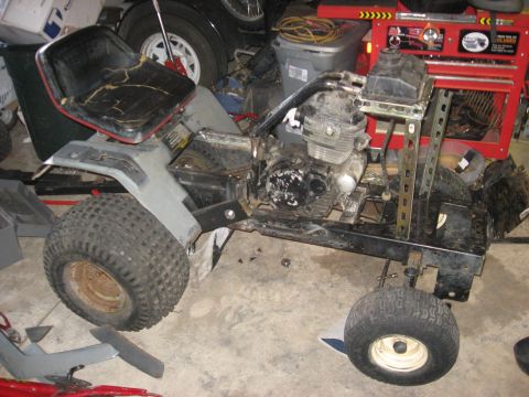 2010 Kawasaki BAYOU 220 - The chassis of an all-terrain vehicle is shown from the side, with its engine and seat visible.