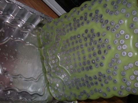 1996 Ford Bronco - A close-up view of a casting mold filled with numerous metal inserts, adjacent to a textured metal component.