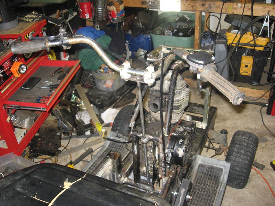 Three-wheeled vehicle front view with engine and handlebars