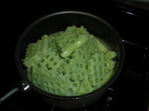 1996 Ford Bronco - Green, waffle-shaped material is shown melting in a pot on a stovetop.