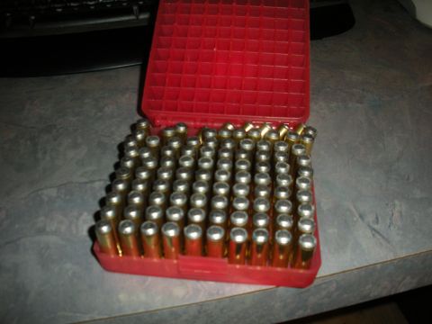 1996 Ford Bronco - A red plastic case holds numerous brass cartridges, suggesting a reloading or ammunition storage context.