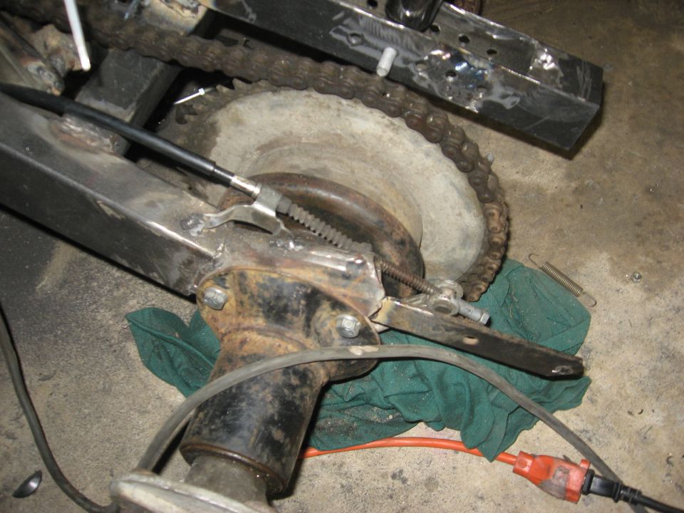 Rear axle and chain assembly with brake mechanism