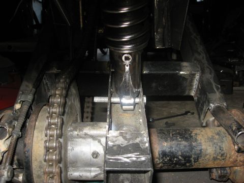 2010 Kawasaki BAYOU 220 - This image shows the rear drive chain and suspension components of an ATV, not a 2010 Kawasaki BAYOU 220.
