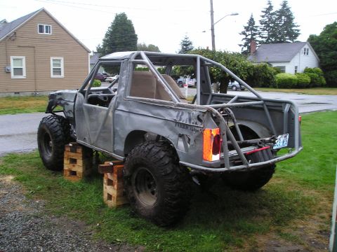 1986 Ford Bronco II - This heavily modified SUV features a full roll cage and oversized tires, suggesting it's built for off-road use.