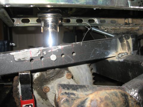 2010 Kawasaki BAYOU 220 - Detail view of a vehicle's undercarriage, showing suspension and drivetrain components.