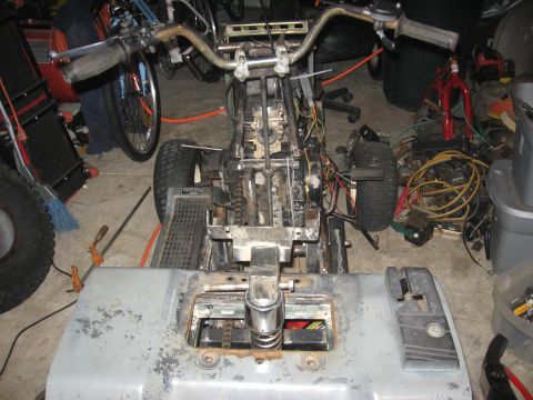 2010 Kawasaki BAYOU 220 - This image shows the disassembled frame and engine of a lawn tractor, with various parts and wiring visible.