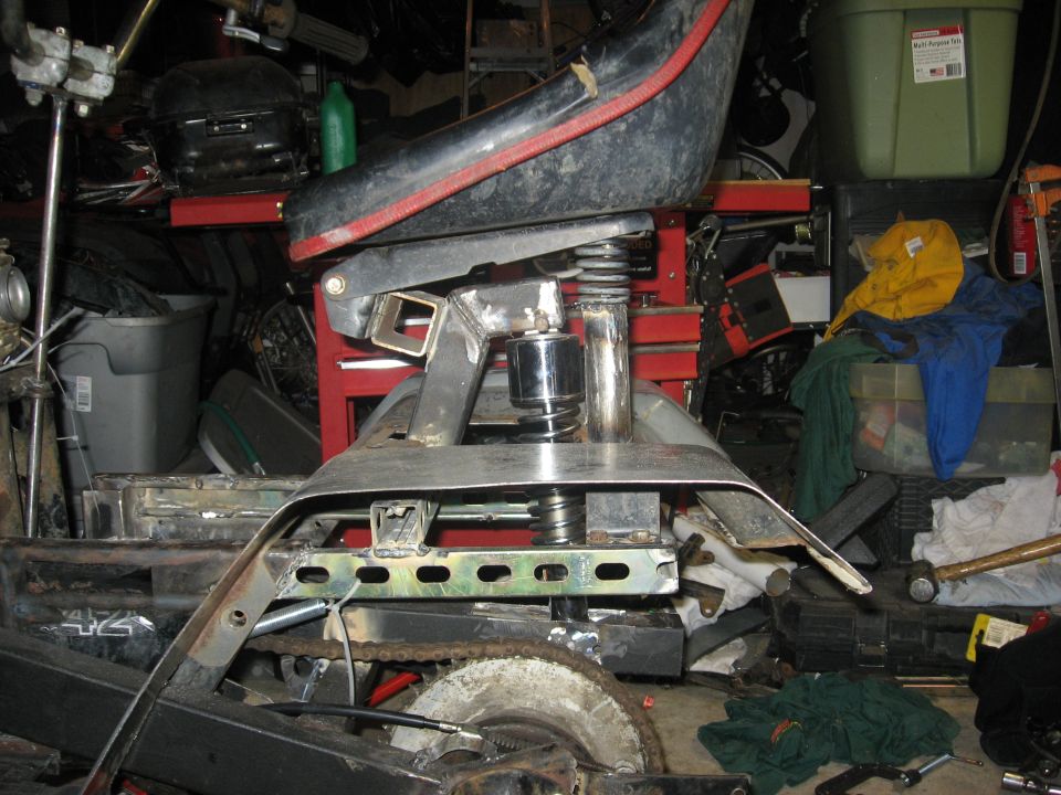 Seat and frame of an ATV, showing suspension and chain drive