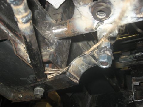 2010 Kawasaki BAYOU 220 - This image shows a close-up view of a vehicle's undercarriage, focusing on metal frame components and fasteners.
