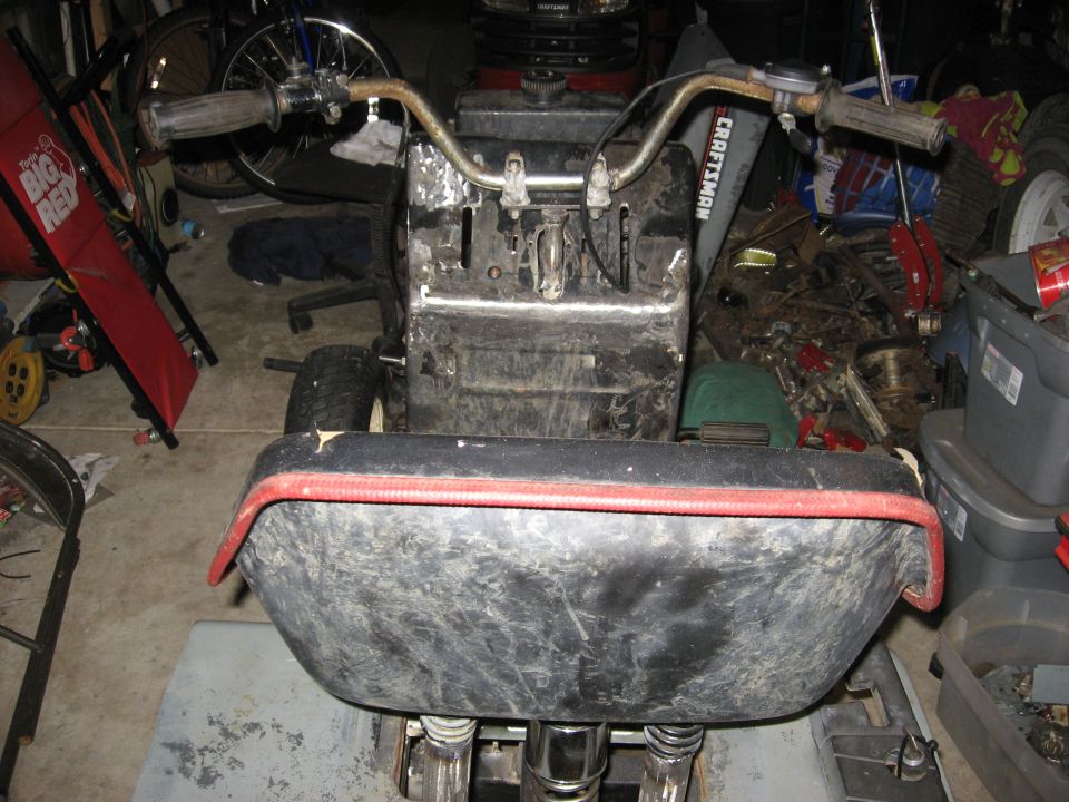Front view of a Craftsman lawn tractor in a cluttered garage