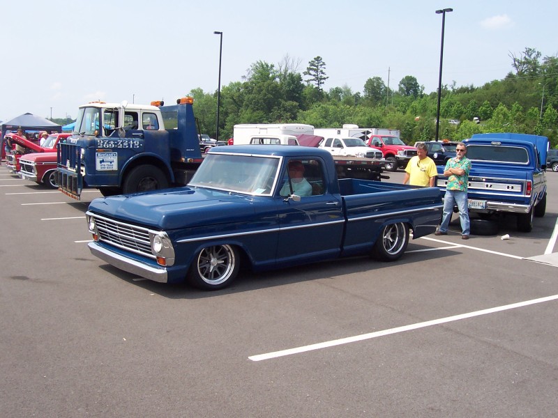 Blue 1967 Ford pickup truck, lowered, with custom wheels