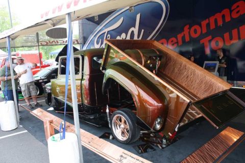2007 Ford Mustang - A custom 1956 Ford pickup truck is displayed with its bed open, revealing a wood-lined interior and a unique paint scheme.