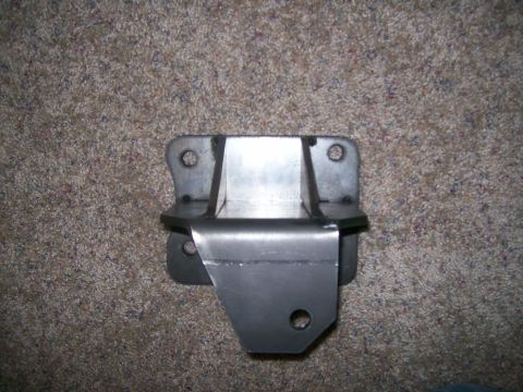 1993 Ford Bronco - A metal bracket, likely a vehicle part, is shown against a carpeted background.