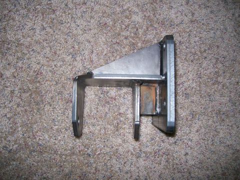 1993 Ford Bronco - A metal bracket, likely a suspension component, is shown against a carpeted background.
