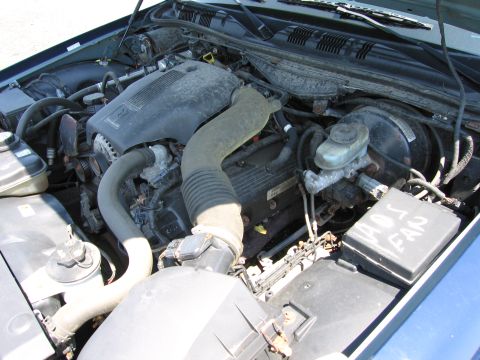 1991 Ford LTD Crown Victoria - The engine bay of a vehicle is shown, with a fuse box cover labeled 'ABS FAN'.