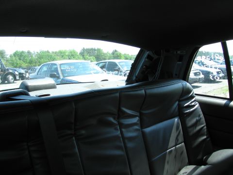 1991 Ford LTD Crown Victoria - View from the back seat of a car, looking out at other vehicles parked in an outdoor lot.