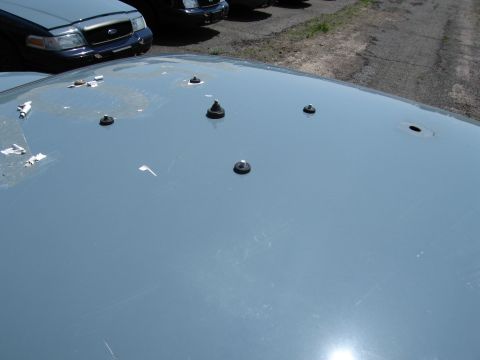 1991 Ford LTD Crown Victoria - Close-up of a 1991 Ford Crown Victoria LTD roof showing studs and holes, with other vehicles in the background.