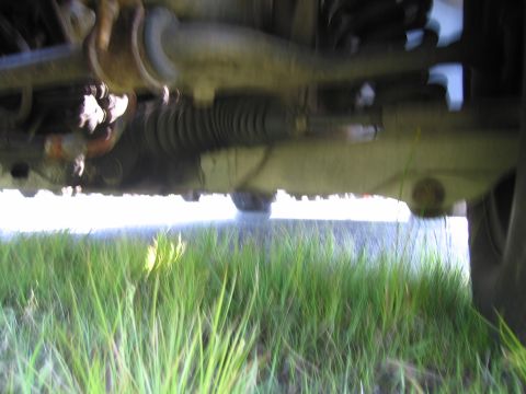 1991 Ford LTD Crown Victoria - Close-up of the steering and suspension components on the underside of a vehicle.