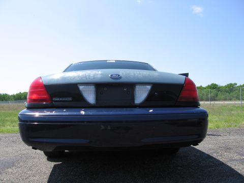 1991 Ford LTD Crown Victoria - Rear view of a dark blue and gray Ford Crown Victoria, showing its taillights and spoiler.