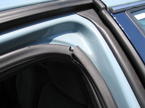 1991 Ford LTD Crown Victoria - The rubber seal around the car door frame shows some wear and tear.