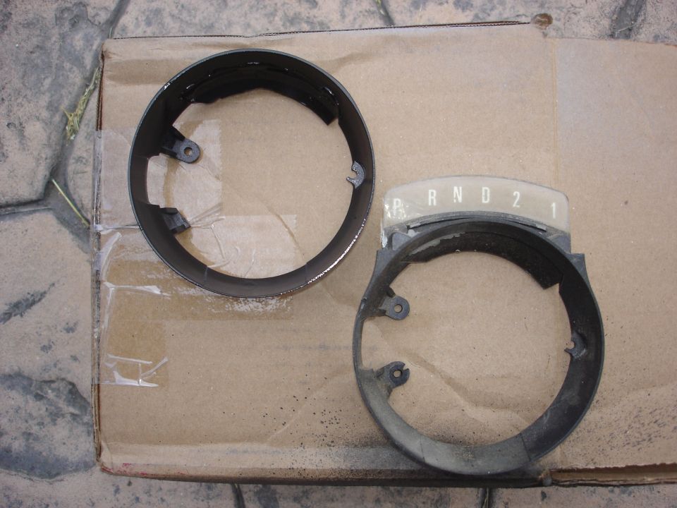 Two circular metal rings, possibly trim rings or bezels, on a light-colored surface