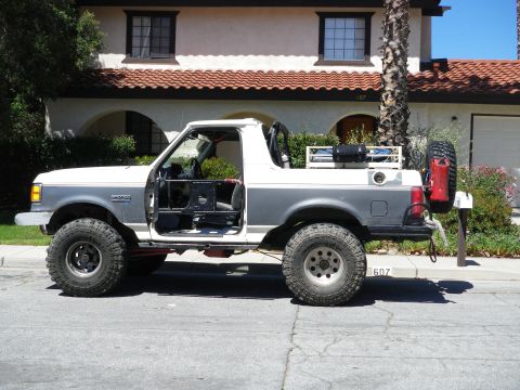 1991 Ford Bronco - This 1992 Ford Bronco is shown from the side with its doors off and a spare tire mounted on the back.