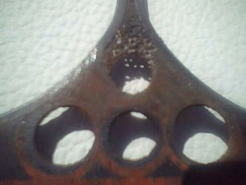 1972 Ford Ranchero - Close-up of a damaged vehicle grille emblem with visible rust and text from Supermotors.net.