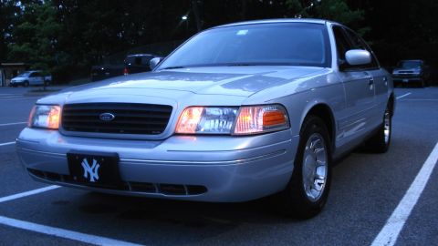 2000 Ford Crown Victoria - Front view of a silver 2000 Ford Crown Victoria with a New York Yankees license plate frame.
