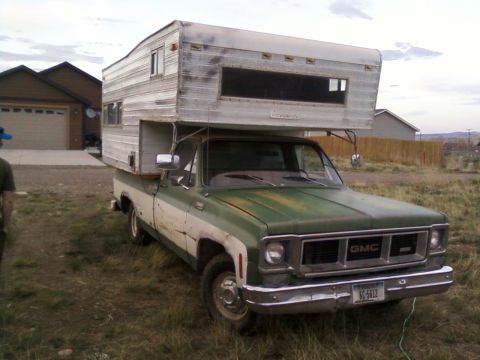 2006 Ford E350 - This vintage GMC pickup truck is outfitted with a camper shell, suggesting it's ready for adventure.