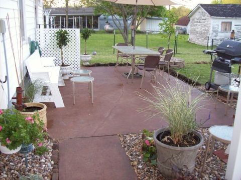 2006 Ford E350 - A backyard patio scene includes outdoor furniture, a grill, and landscaping.
