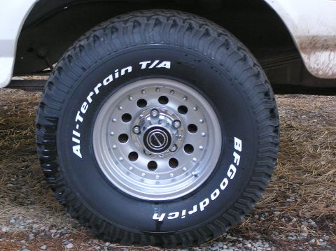 1993 Ford Bronco - A close-up view of a BFGoodrich All-Terrain T/A tire mounted on a vehicle's wheel.