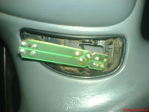1998 Ford Crown Victoria - A detached cruise control circuit board is shown removed from its housing.