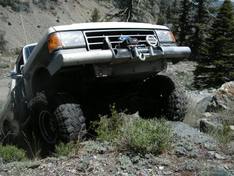 1982 Ford Bronco - Modified pickup truck navigating a challenging rocky off-road course.