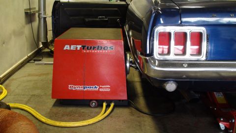 1970 Ford Mustang - A blue 1970 Ford Mustang is positioned on a red AET Turbos Dynapack dynamometer for performance testing.