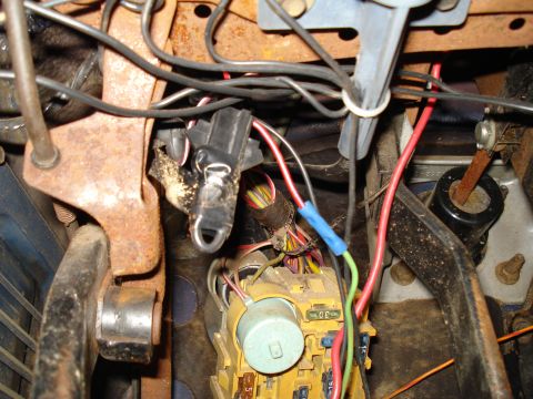 1985 Ford F-150 - A tangled mess of wires and a fuse box are visible in this close-up shot of a vehicle's interior components.