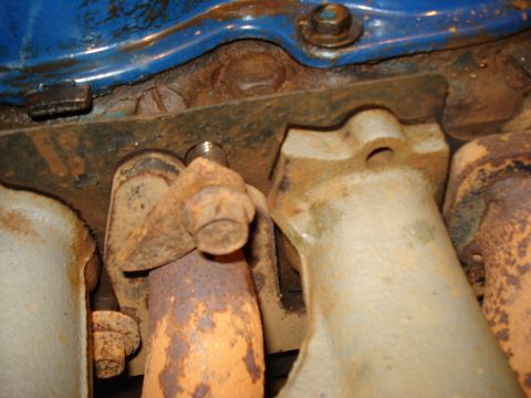 1985 Ford F-150 - Bolts securing the exhaust manifold to the engine block show significant rust and wear.