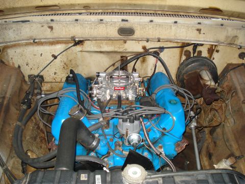1967 Ford F-250 - Close-up view of a V8 engine, a prominent Edelbrock carburetor and blue valve covers.