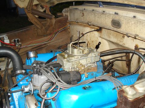 1967 Ford F-250 - Close-up view of the engine bay in a 1967 Ford F-250, highlighting the carburetor and blue valve covers.