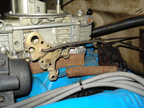 1967 Ford F-250 - The carburetor linkage and spring are visible in this close-up engine shot.