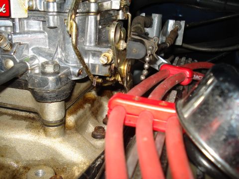 1967 Ford F-250 - Engine detail showing a carburetor and spark plug wires, part of a vehicle's ignition system.