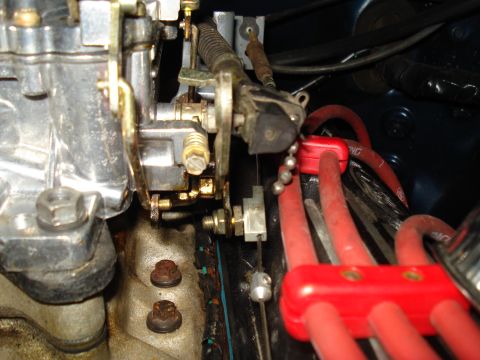 1967 Ford F-250 - Detail shot of engine components, including a carburetor and red spark plug wires, likely from a classic vehicle.